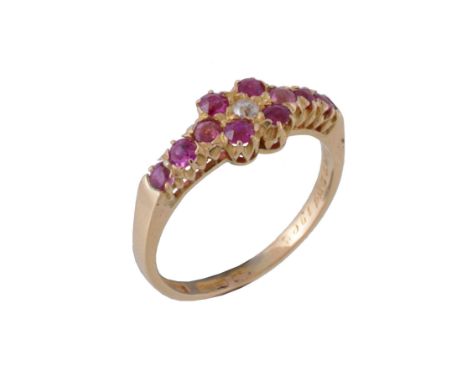  An Edwardian ruby and diamond ring,   the quatrefoil of rubies with an old cut diamond to the centre, to circular cut ruby s