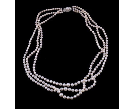 A three strand cultured pearl necklace by Mikimoto,   composed of graduating cultured pearls, to the cultured pearl set clas