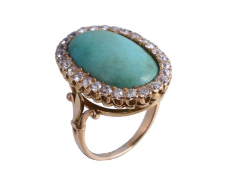  A turquoise and diamond ring,   the oval cabochon turquoise within a surround of old brilliant cut diamonds, approximately 0