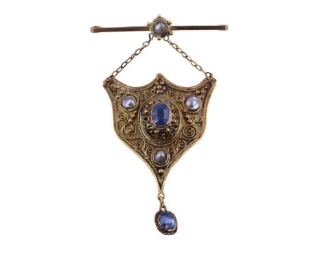  A sapphire and pearl pendant,   the shield shaped panel with applied scroll and bead work, set with an oval cut sapphire and