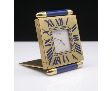 Must de Cartier, a quartz travel clock, the square lacquered brass case with blue enamelled batons above and below signed to 