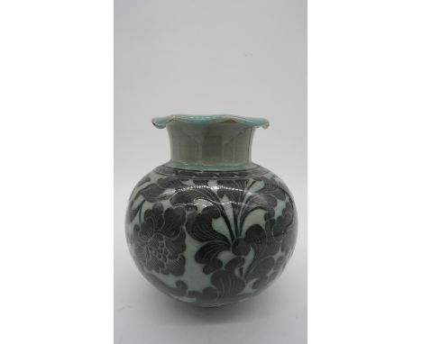 A 20th century Korean celadon glaze ceramic baluster vase with ruffled rim. Decorated with a stylised floral and foliate desi