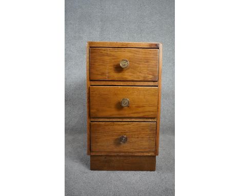 A mid century vintage light oak pedestal chest of three drawers on plinth base. H.64 W.35 D.45cm 