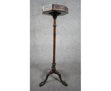 A late 19th century mahogany urn stand with pierced galleried top on carved pedestal with tripod cabriole ball and claw suppo