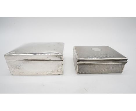 Two antique cedar lined sterling silver cigarette boxes. One with zigzag engine turned decoration and circular cartouche hall