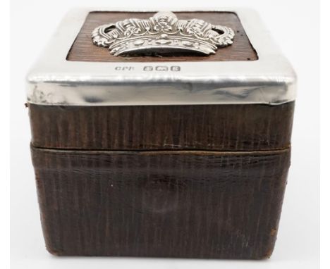 A sterling silver and brown leather brass travelling ink well. The top has a repousse work silver crown with silver border. I