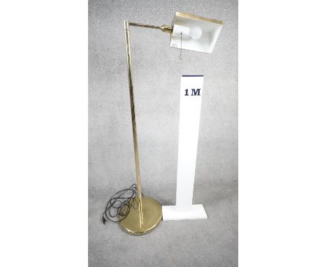 A vintage solid brass swing arm floor lamp with triangular shade, painted white interior and circular weighted base. Two pin 