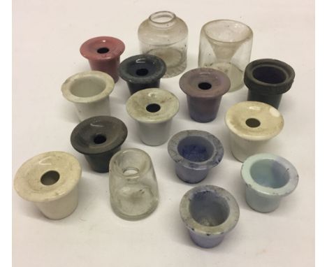 A selection of c19th century and later ceramic and glass ink wells.