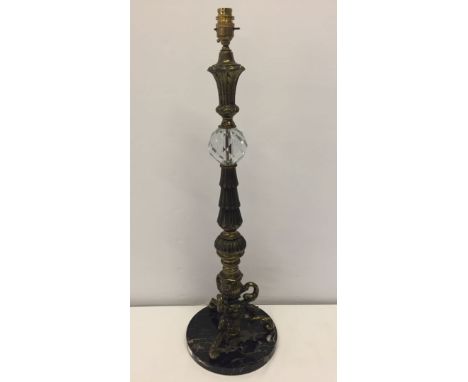 An ornate metal table lamp with marble base and glass section. 72cm tall.