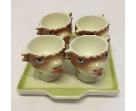 4 Goebel eggcups in the shape of cows heads complete with tray.