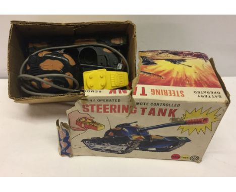 A Marx Toys boxed remote controlled, battery operated Steering Tank.  Box in poor condition.