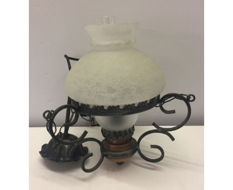 An oil lamp style ceiling light fitting.