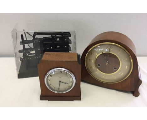 Two wooden cased mantel clocks together with a ball bearing time machine.