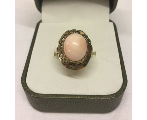 Ladies vintage silver gilt cocktail ring set with coral in an oval decorative mount.  Size O