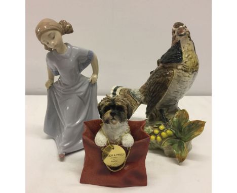 3 porcelain figures comprising: Girl by Nao #1558, a Beswick style hame bird and Leonardo Collection terrier in a bag by Less