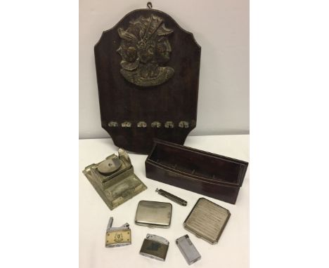 A small collection of smoking related items to include pipe rack and engine turned cigarette cases.