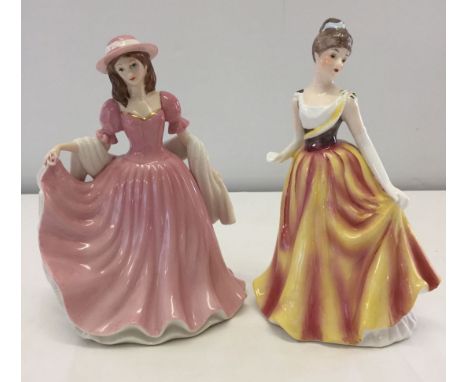 2 Leonardo Collection ceramic figurines. One by Annie Rowe in pink dress.