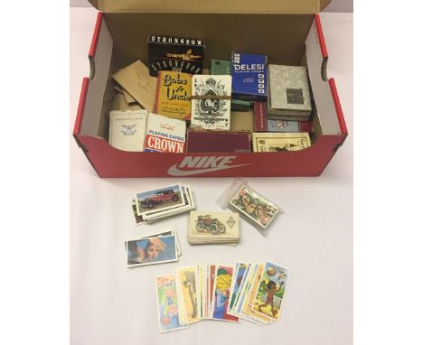 A box of playing cards and mixed teacards.