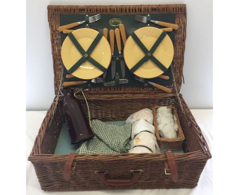 A vintage 'Optima' wicker picnic hamper with contents.