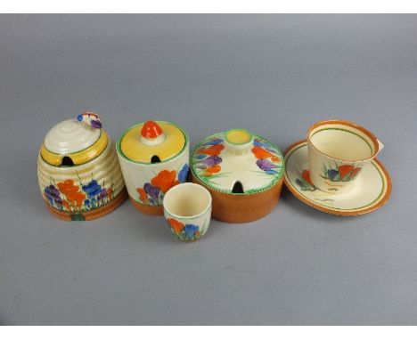 A COLLECTION OF CLARICE CLIFF CROCUS PATTERN WARES, comprising two circular preserve pots and covers, an egg cup, a honey pot
