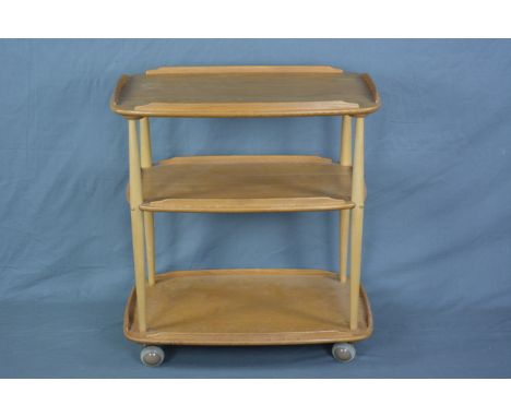 AN ERCOL ELM THREE TIER GALLERY TEA TROLLEY, with beech uprights, on casters, approximate width 71.5cm x depth 46cm x height 