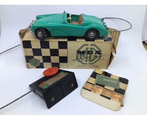 Victory: A boxed Victory Industries, Surrey, remote control, battery operated, MGA, green with tan interior, some warping to 