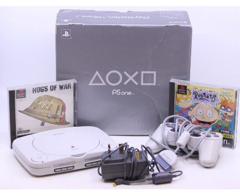 PlayStation: A boxed PSone console, complete with control pad, PSU and two cased games: Rugrats and Hogs of War. (3)
