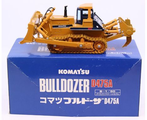 Komatsu: A boxed Komatsu, Bulldozer, 1:50 Scale, D475A, vehicle appears good, in original box, slight wear to edges; together