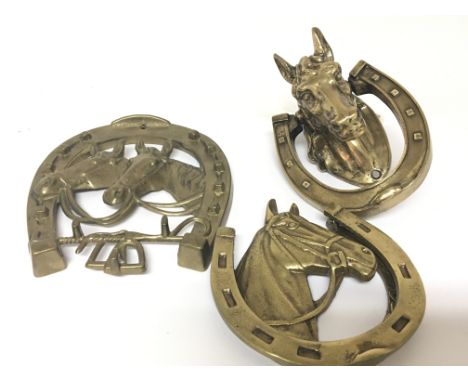 A cast brass door knocker in the form of a horse head one other and a horse and horse shoe coat hanger (3) 13cm, 20cm (3)