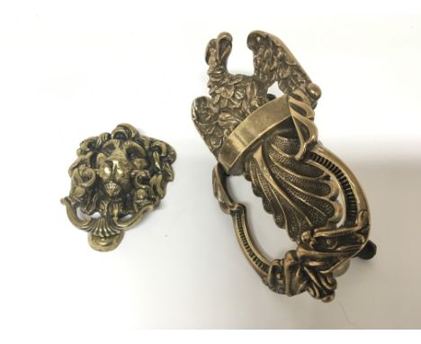 An Antique cast brass door knocker of American design with an egalitarian above a shell scroll and a brass door knocker in th