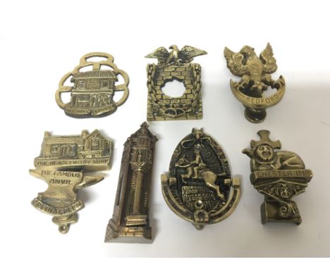 A collection of six cast brass Novelty door knocker and a horse brass Bedford The Blacksmiths shop Gretna Green and others (7