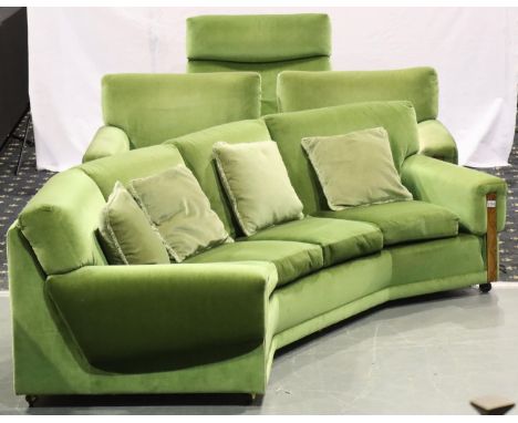 Mid 20th century four piece lounge suite comprising a curved four seat sofa, pair of armchairs and a larger armchair, each up