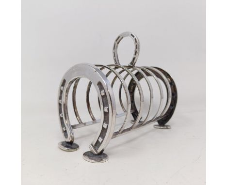 A late Victorian silver plated novelty toast rack, the ends in the form of horseshoes, 14 cm wide