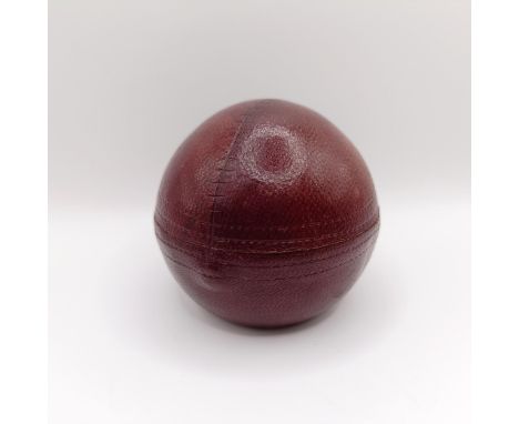 A Victorian novelty inkwell, in the form of a cricket ball, 7 cm diameter
