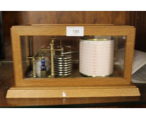 A DISPLAY BAROGRAPH with glazed oar framed cover together with a quantity of related paperwork from 'The Barometer Shop'