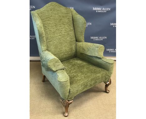 An upholstered wing back scroll arm chair in the Georgian style, raised on cabriole front legs to pad feet, 84 cm wide x 79 c