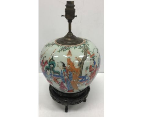 A 19th Century Chinese famille-rose ginger jar, the main body decorated with figures and children in a garden setting, raised