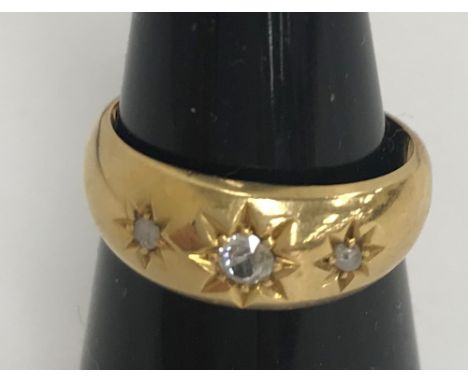 An 18-carat gold three stone diamond ring, size L, 5.3g CONDITION REPORTS The piece is hallmarked - see image for marks.  Con
