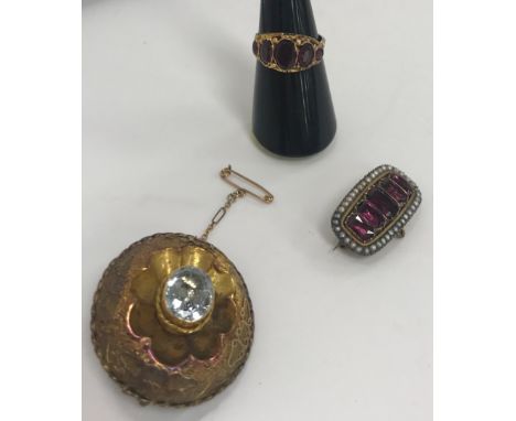 A gold garnet and seed pearl brooch, a pinchbeck and paste mourning brooch and a garnet five stone ring size M
