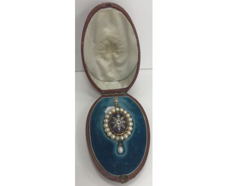 A yellow metal mounted pendant, the clasp set with seed pearl and four small diamonds, the main oval pendant set with diamond