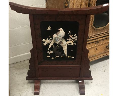 An early 20th Century Japanese lacquered shibyama screen with shaped top above a panel depicting pheasants on floral decorate