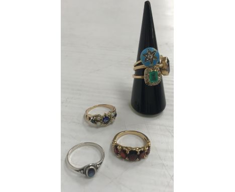 A collection of five various gold rings including a five stone graduated garnet ring, size L, a single stone amethyst ring, s