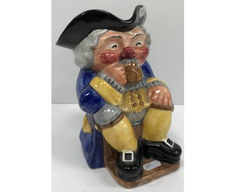 A Clarice Cliff Toby jug as a seated Toby supping a beer, bears "Clarice Cliff Newport Pottery Company Ltd" mark to base, 21.