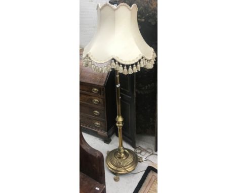An early 20th Century brass telescopic lamp standard with lion paw feet and shade 135cm inc fitting