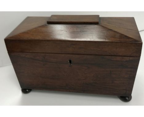 A Victorian rosewood sarcophagus shaped tea caddy with hinged lid opening to reveal a fitted interior and cut glass bowl (pos