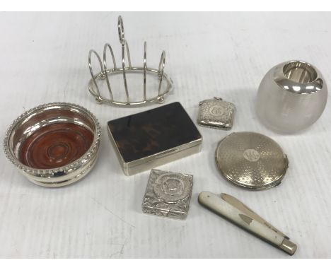 A collection of silver wares comprising silver four section toast rack of simple form, a silver mounted ribbed glass match st