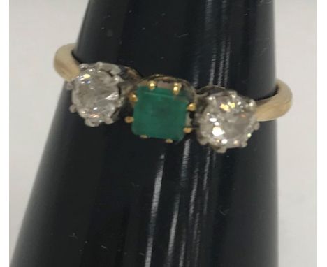 An 18-carat gold diamond and emerald three stone ring, size O, 2.2g CONDITION REPORTS The stones appear to be, with the naked