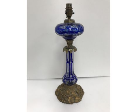 A late Victorian Bohemian blue overlaid glass and brass table oil lamp in the Rococo style, converted to electricity, 48 cm h