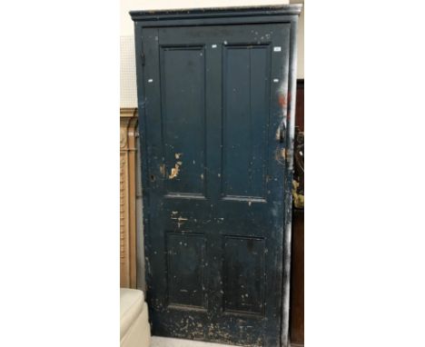 A Victorian painted pine cupboard, the moulded cornice above a four panel door enclosing a pigeon-holed interior of 43 sectio