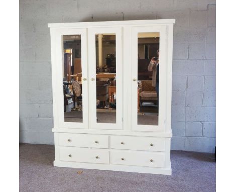 A large modern white painted wardrobe, fitted with hanging space, linen shelves and drawers, 150cm wide by 184cm high by 53cm